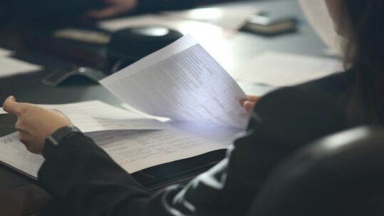 Woman reviewing paperwork at a desk