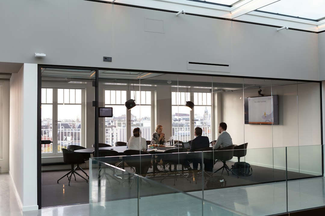 Colleagues discussing documents in a meeting room